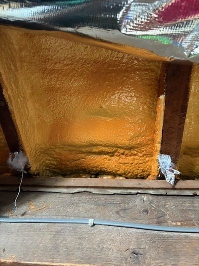 closed cell spray foam insulation hidden behind foil blanket. For independent insulation advice and foam removal quotes contact us today  07350 559720