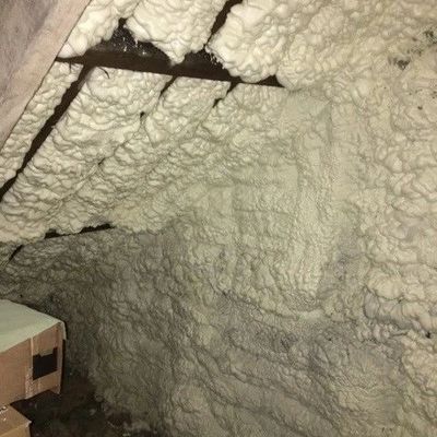 Spray foam insulation covering attic walls and ceilings, Our contractors provide foam removal quotes and insulation advice.