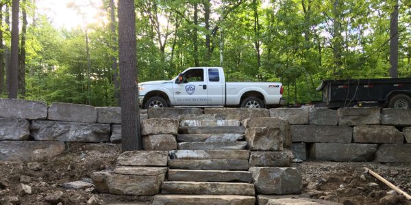Armour stone steps and retaining walls with SJS pickup truck at top of stairs.