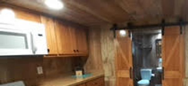 Kitchen overview, stove, microwave, sink cabinets, water faucet
