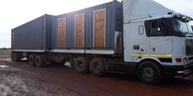 Truck trailer with multiple wooden doors.