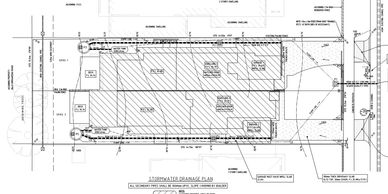 Technical stormwater drainage plan for a residential site showing drainage pipes and structures.