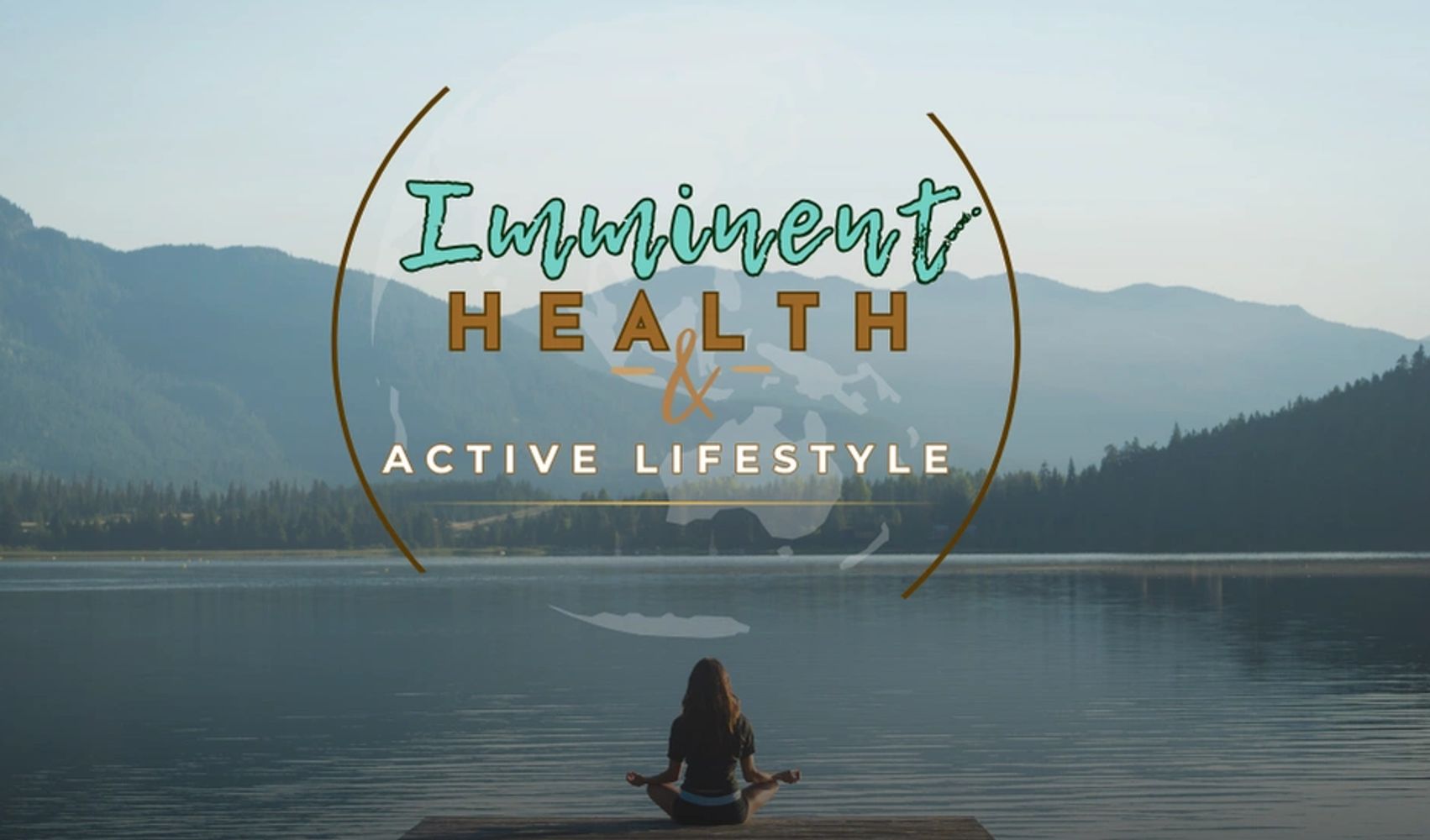 Person meditating by a serene lake surrounded by mountains, promoting health and active lifestyle.