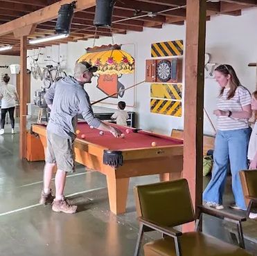 Families playing pool in the clubhouse.