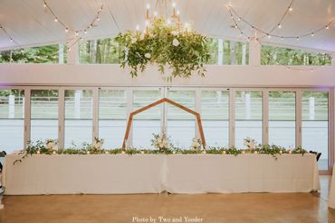 White linen table cloth over handcrafted farm tables for a lush green wedding in Middle Tennessee.