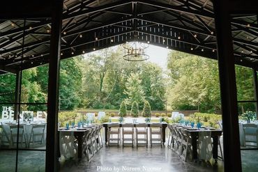 Wedding reception dinner on the covered patio at The Barn wedding venue at Firefly Lane Weddings.