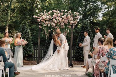Tennessee garden wedding ceremony with blush pink floral arrangement on a wedding ceremony arch.