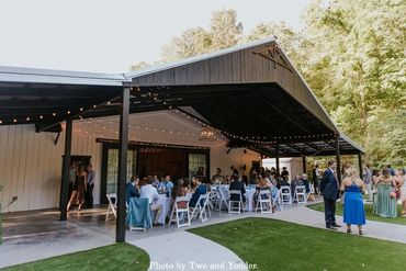 Cocktail hour on the covered patio at Firefly Lane barn wedding venue.