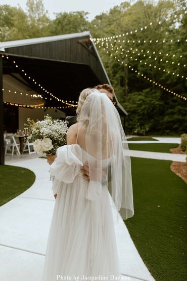 Bride and groom enter cocktail hour on the lawn after their wedding ceremony.