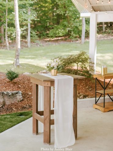 Wedding cocktail tables for an outdoor cocktail hour in the courtyard at Firefly Lane Weddings.