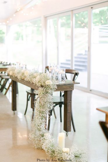 Baby's breath cascading floral arrangement on a wedding sweetheart table.