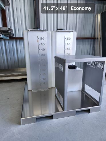 Two white tanks with metal measurement panels on a metal platform.