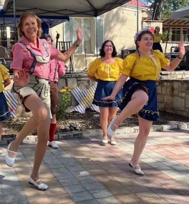 2 dancers doing Schuhplattler (German kicks)