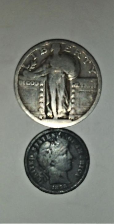 Two vintage U.S. coins, one standing Liberty and one Barber dime from 1896.