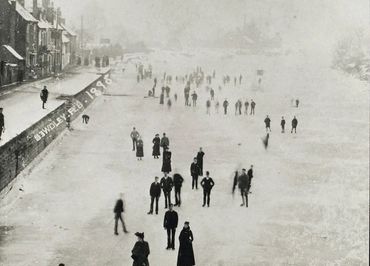 Historical photo of people standing on a frozen river in 1896.