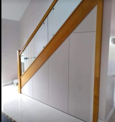 Bespoke under-stairs storage cabinets and staircase joinery in Sutton, Wallington and South London