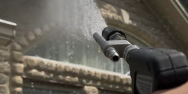 Soft wash being applied to the eaves of the home.