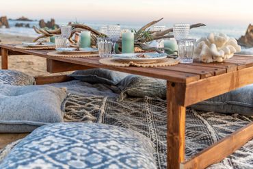 side view of dining table showing pillows and blankets for seating and tabletop decor