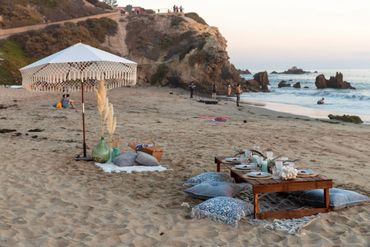 Corona Del Mar State Beach with a bohemian style picnic setup, overview photo.