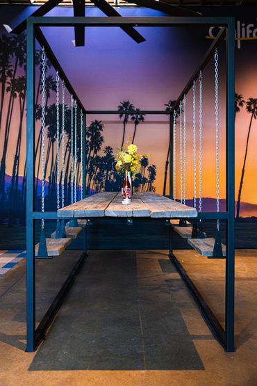 overview of swing set table with wine bottles and floral centerpiece