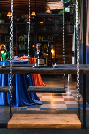 swing set seating with wine bottles on table
