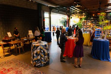event overview with colorful tables, wine tasting station and open to outside
