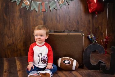 One year baby boy posing for his one year old cakesmash