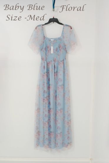 Baby blue floral dress with puff sleeves hanging on a black hanger.