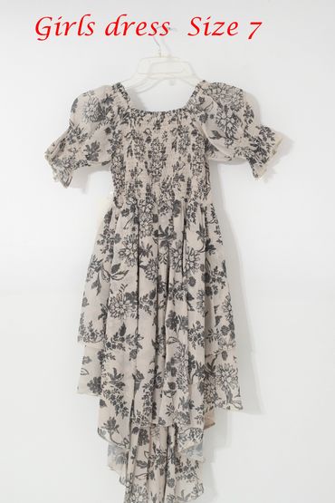 Floral girls' dress size 7 with puff sleeves and layered skirt.