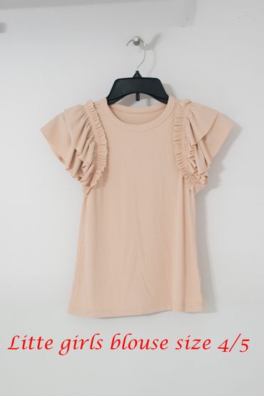 Beige little girls blouse with ruffled sleeves, size 4/5, hanging on a black hanger.