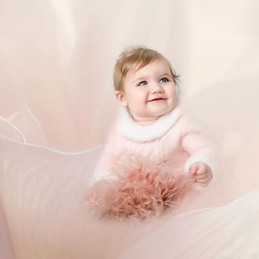 6 month old posing for her milestone pictures with AI editing for the background
