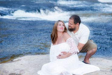 Young couple taking Maternity photos at beautiful Hurricane Shoals park