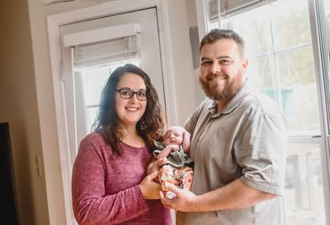 In home newborn session with mom and dad