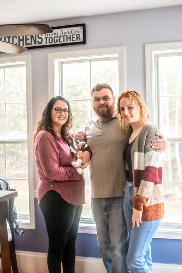 In home newborn session with mom and dad and big sister
