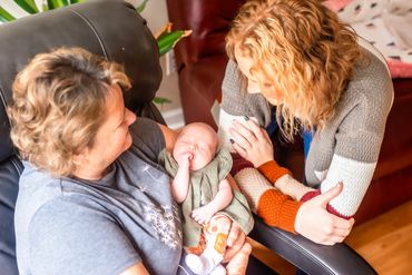 In home newborn session with grandma and big sister