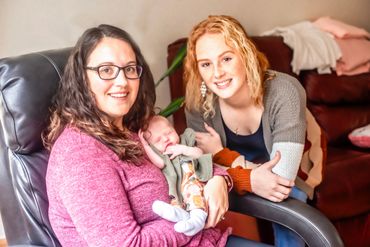 In Home Newborn session with baby girl and mommy and big sister