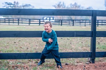 3 year old toddler boy laughing and playing for his photos