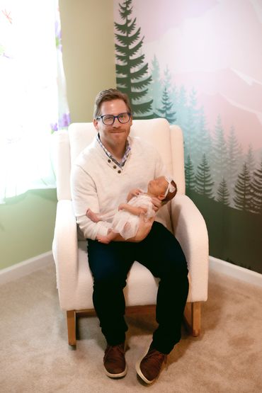 In Home newborn session with Dad holding baby