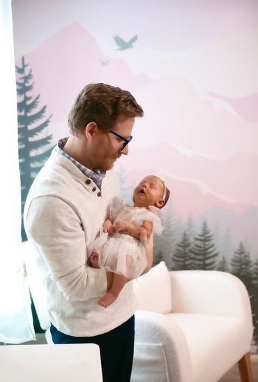 In Home newborn session with Dad holding baby
