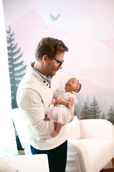 In Home newborn session with Dad holding baby