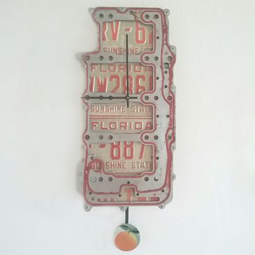 Florida license plates engine part wall clock.  Artist, Steven Shaver.