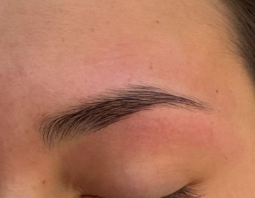 Close-up of a well-groomed eyebrow on smooth skin.
