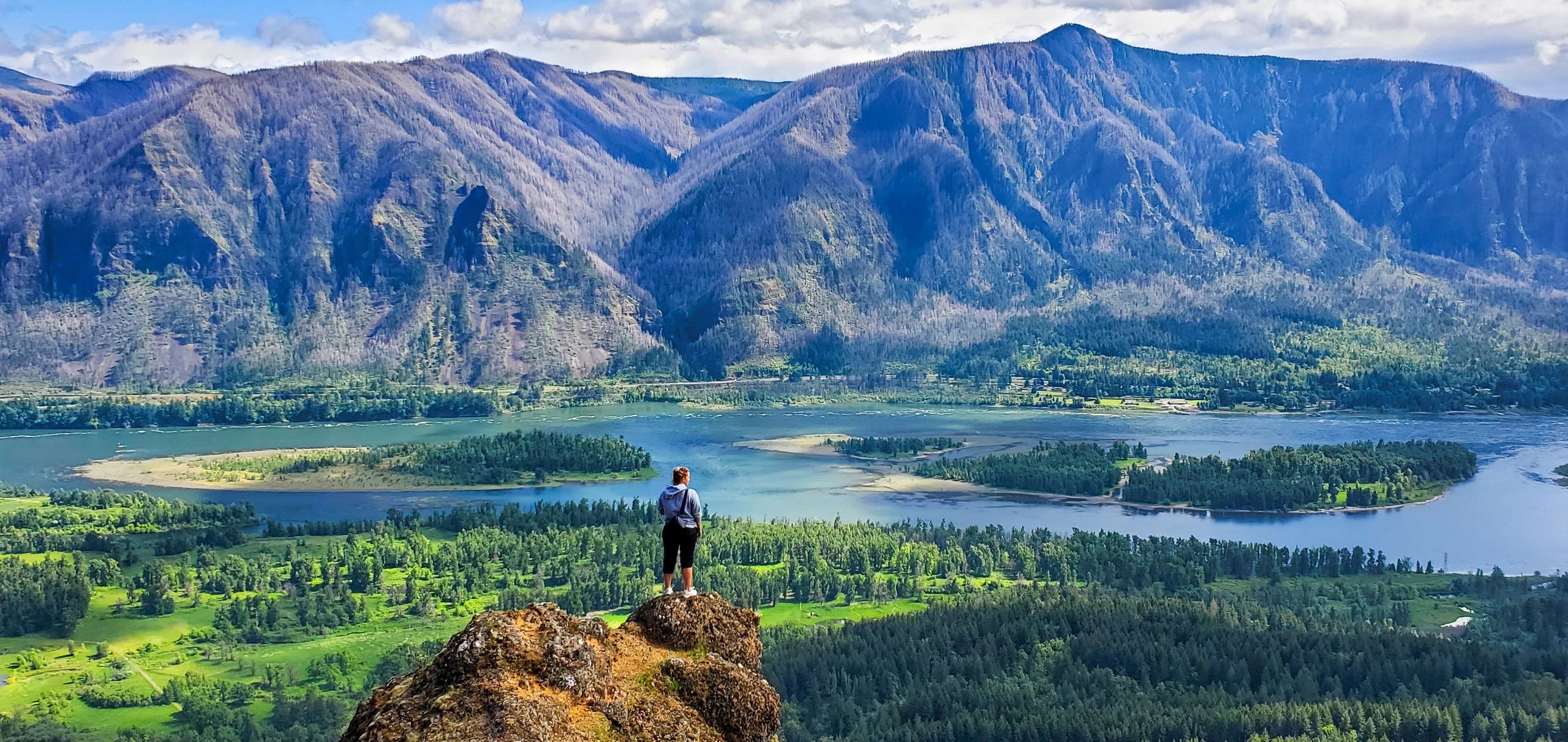 woman standing on a cliff over looking the Columbia River