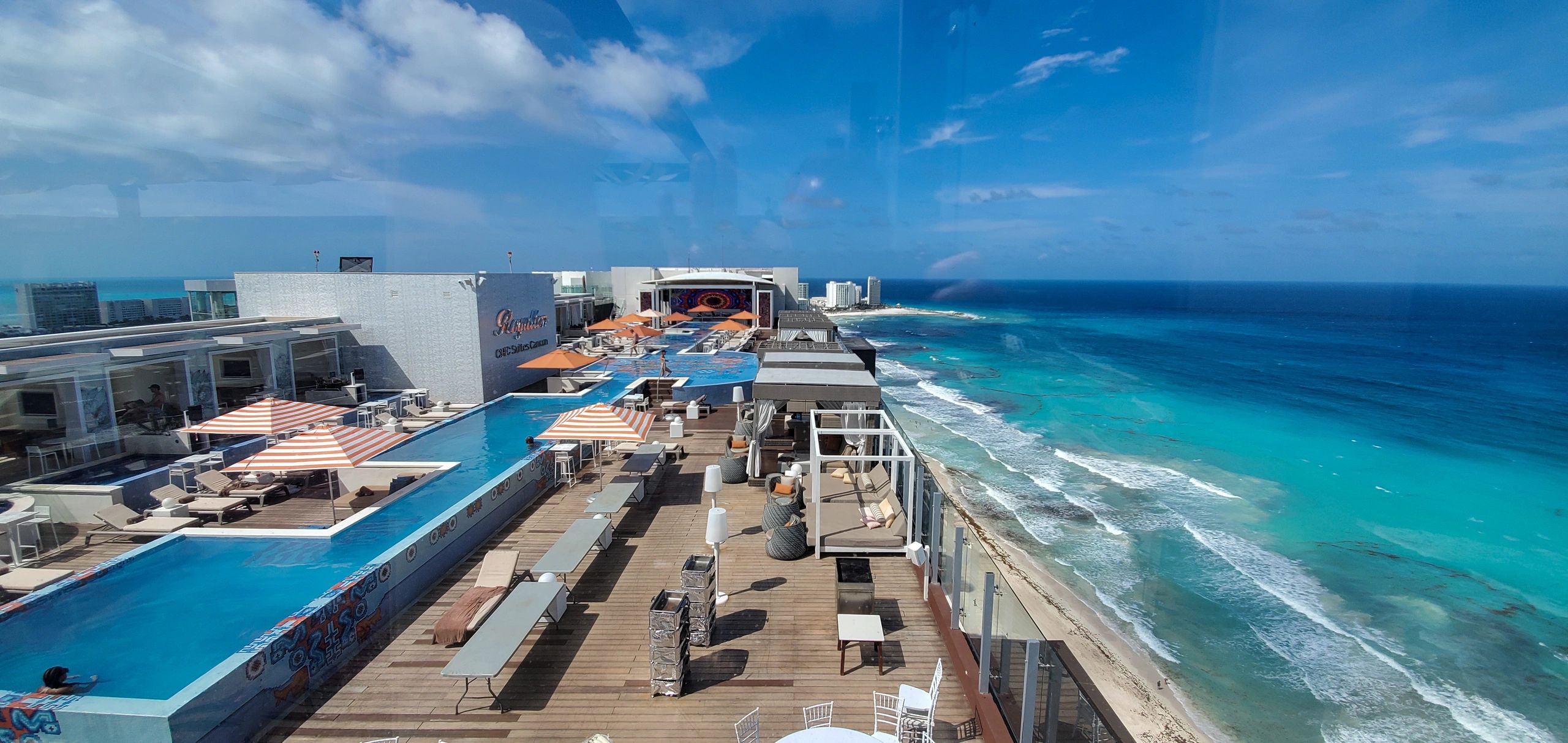 ROOFTOP POOL AT THE ROYALTON CHIC SUITES CANCUN SITTING NEXT TO THE CARIBBEAN OCEAN