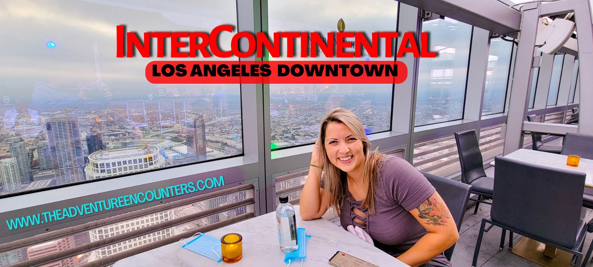 woman sitting on a rooftop bar at the InterContinental Los Angeles Downtown