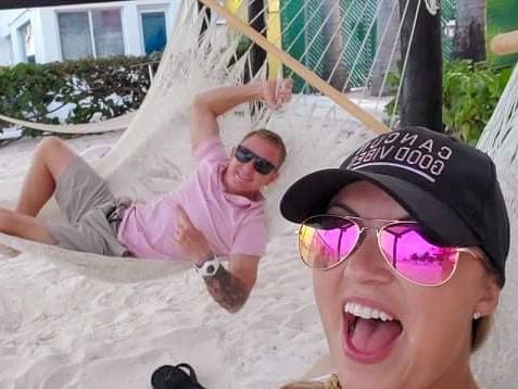 man and woman sitting in hammocks on the beach in Cancun Mexico
