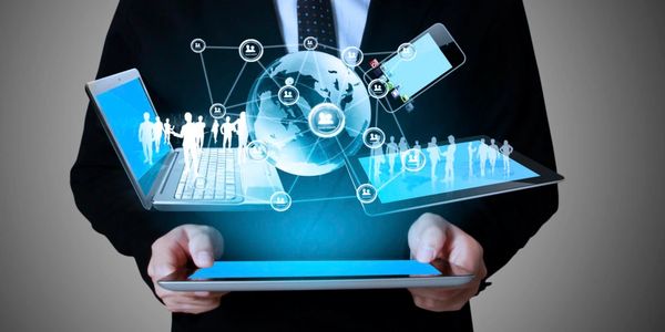 Businessman holding a tablet with holographic social network and digital devices.