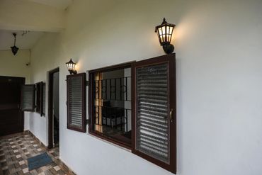 First Floor Corridor with traditional wooden windows and antique lamps leading to the ac family stud