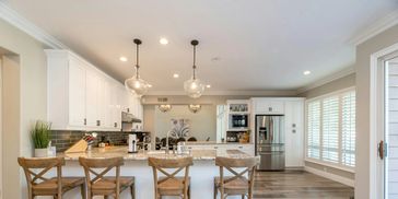 Kitchen Remodel with white cabinets, new appliances and room for four at the counter
