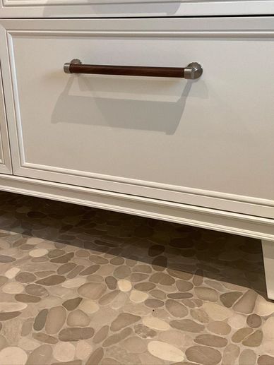 Pebble flooring in hall bathroom